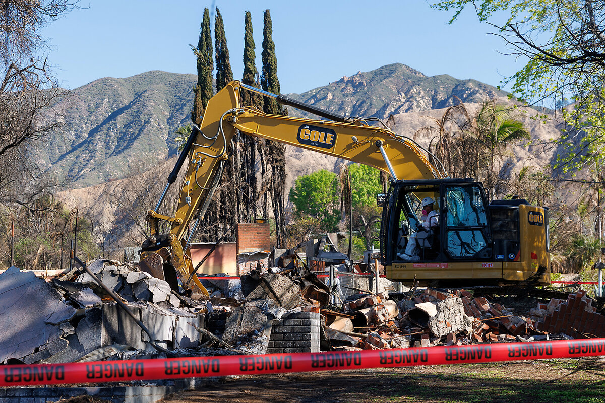 Workers use heavy equipment to remove debris from a destroyed home following the Eaton Fire in Altadena, California, March 10, 2025.  